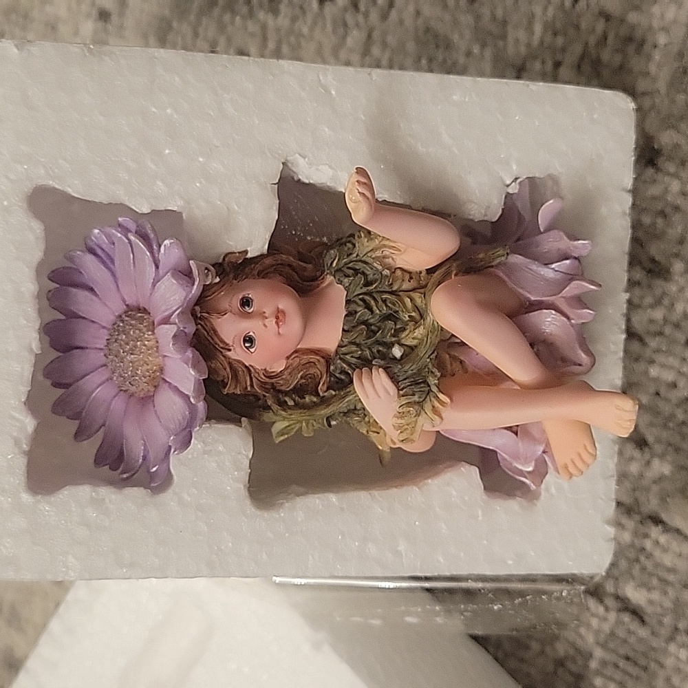 Little girl fairy with a purple flower